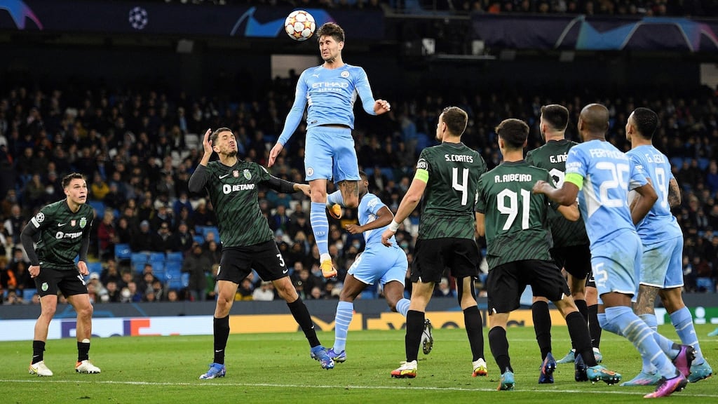 Manchester City’s John Stones (centre) jumps to head at goal but fails to score during the Champions League round of 16 second-leg match against Sporting Lisbon at the Etihad Stadium in Manchester on Wednesday night. Photograph: Oli Scarff/AFP via Getty