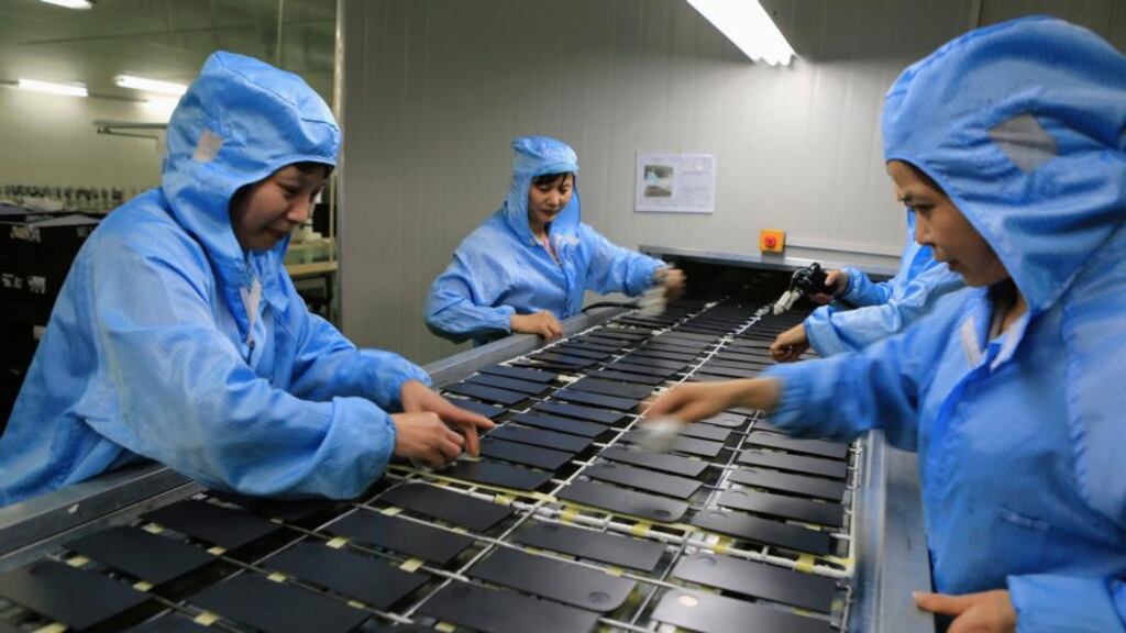 Workers process laptop accessories at a factory in Dazu, Chongqing Municipality, China. Photograph: Reuters