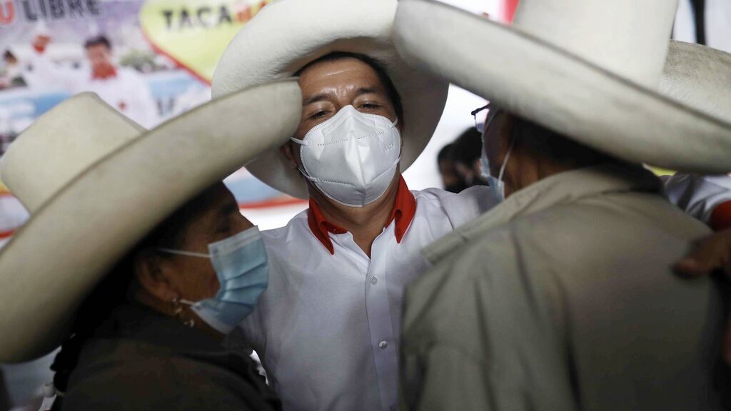 Pedro Castillo of the Peru Libre party celebrates as the first results, according to an exit poll published as the polling stations closed on Sunday, indicated he received the most votes. Photograph: Francisco Vigo/EPA