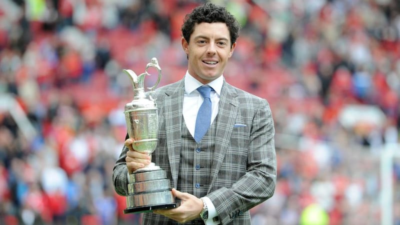 Rory McIlroy holds the British Open Claret Jug on the Old Trafford pitch during half time. Photograph :Martin Rickett/PA Wire.