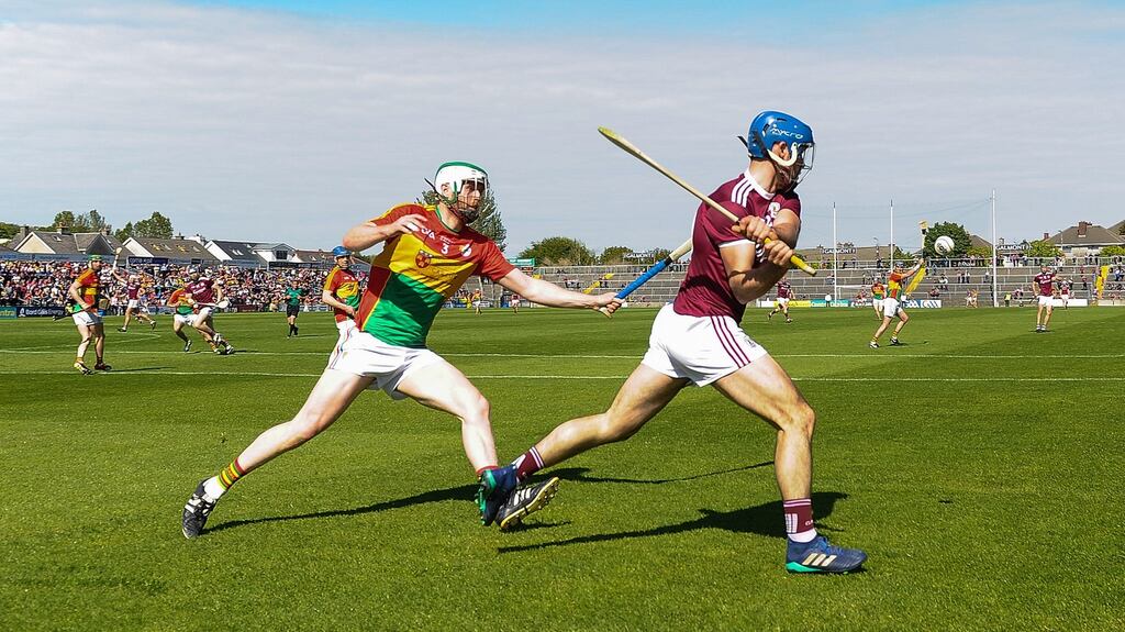 Galway’s Johnny Coen clears away from Paul Doyle of Carlow. Photograph: Tommy Grealy/Inpho