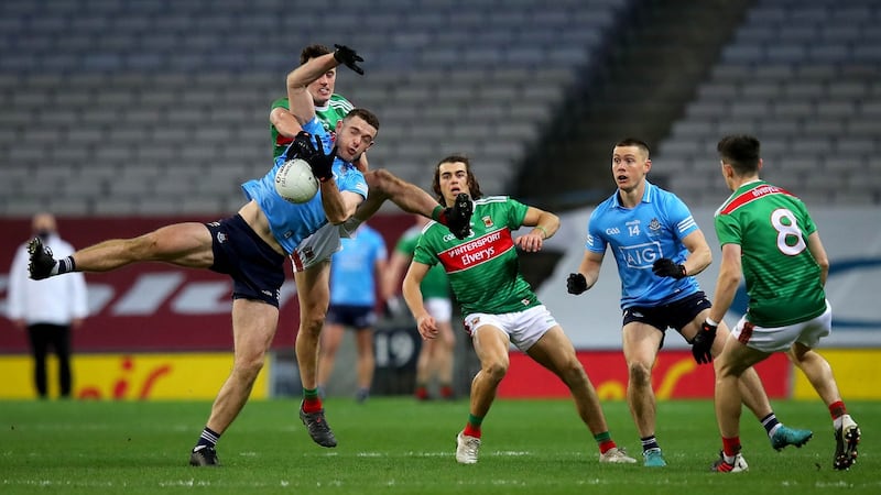 Fenton catches under pressure from Diarmuid O’Connor. Photo: Ryan Byrne/Inpho
