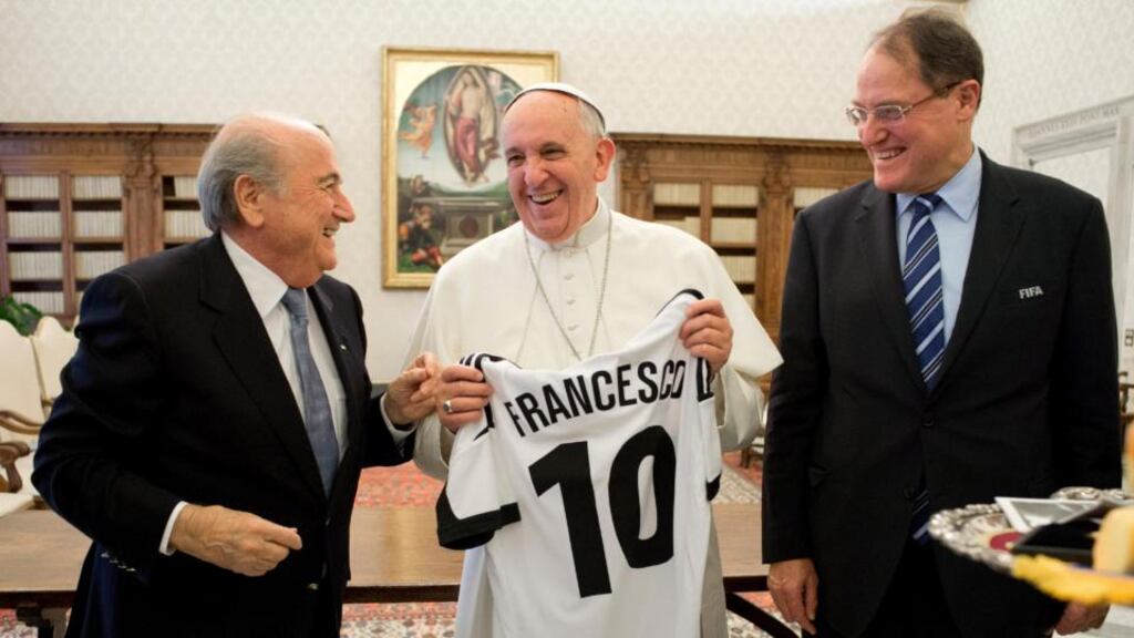 In this photo provided by the Vatican newspaper L’Osservatore Romano Pope Francis is presented with a jersey reading his name during a meeting with Fifa president Sepp Blatter (left) at the Vatican. “We spoke the same language and it was language of football,” Blatter said.