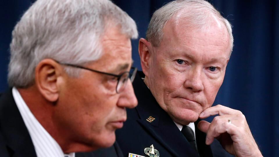 Chairman of the Joint Chiefs of Staff Gen. Martin Dempsey (right) listens to US secretary of defense Chuck Hagel (left) talk in a press briefing at the Pentagon in Washington last night. Photograph: Reuters