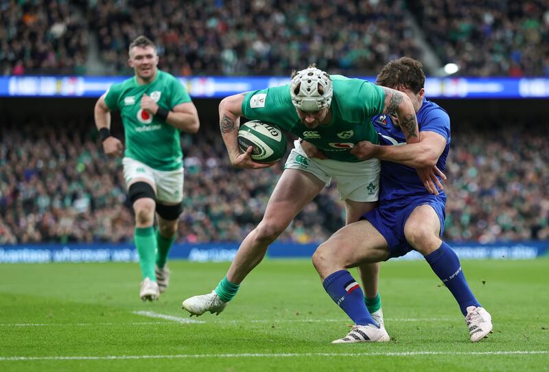 Mack Hansen of Ireland is tackled by Antoine Dupont of France. Photograph: David Rogers/Getty