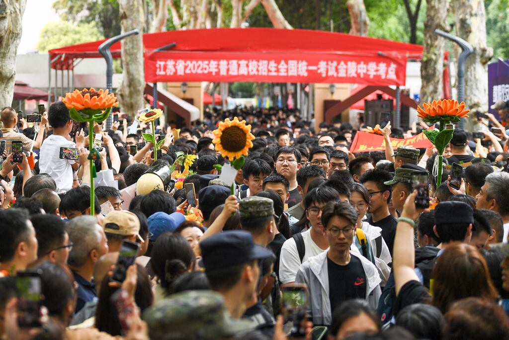 Students walk out to meet their parents after sitting China's National College Entrance Examination (NCEE) known as the "gaokao", earlier this week. Photo: STR/AFP via Getty Images