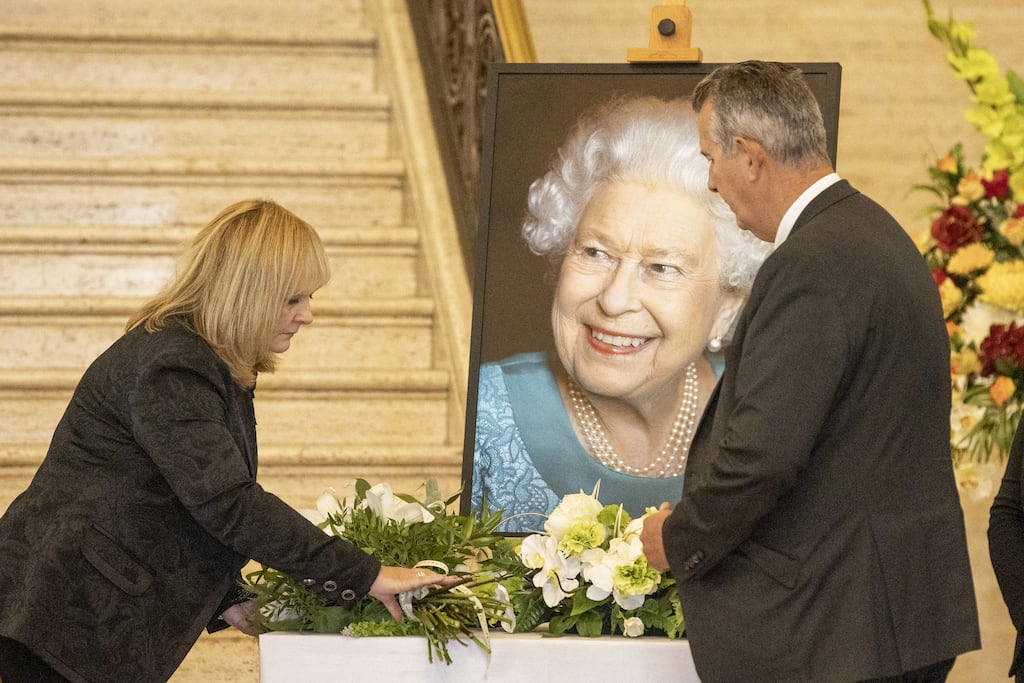 DUP MLAs Michelle McIlveen and Edwin Poots during a lying of sympathy flowers at a portrait of Queen Elizabeth II in the Great Hall of Parliament Buildings at Stormont in where a book of condolence was opened. Photograph: PA Wire