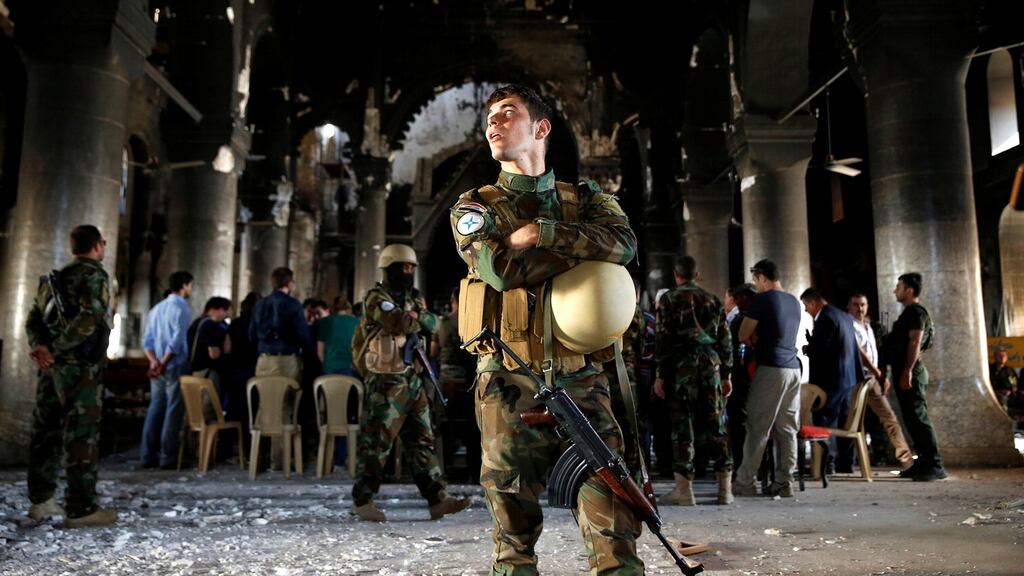 Iraqi Christian soldiers attend the first Sunday mass at the Grand Immaculate Church since it was recaptured from Islamic State in Qaraqosh, near Mosul, in Iraq. Photograph: Ahmed Jadallah/Reuters