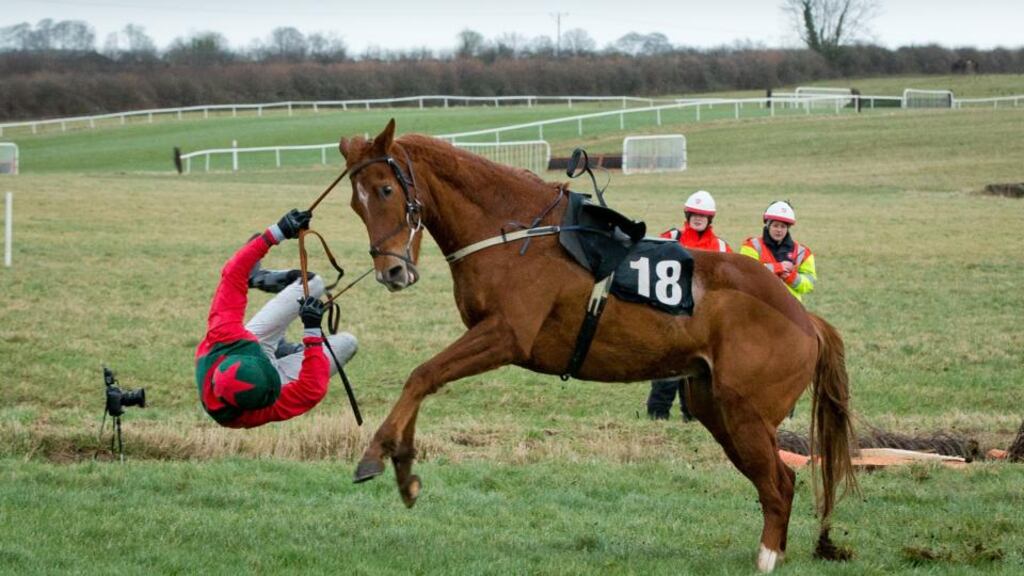 Martin Burke falls from Mr Moondance at the last fence in the www.thurlesraces.ie Maiden Hurdle at the Co Tipperary track. Photograph: Morgan Treacy/ INPHO
