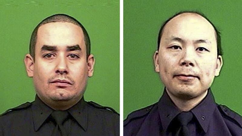 A New York City Police Department handout picture showing officers Rafael Ramos (left) and Wenjian Liu (right), who were, according to NYPD Commissioner William Bratton, killed while sitting in their patrol car in the Brooklyn borough of New York. Photograph: EPA