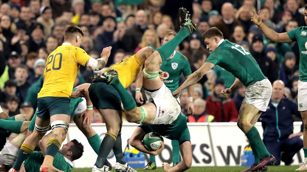 Ireland’s Devin Toner is dumped by Bernard Foley of Australia in the last few minutes at the Aviva Stadium. Photo: Morgan Treacy/Inpho