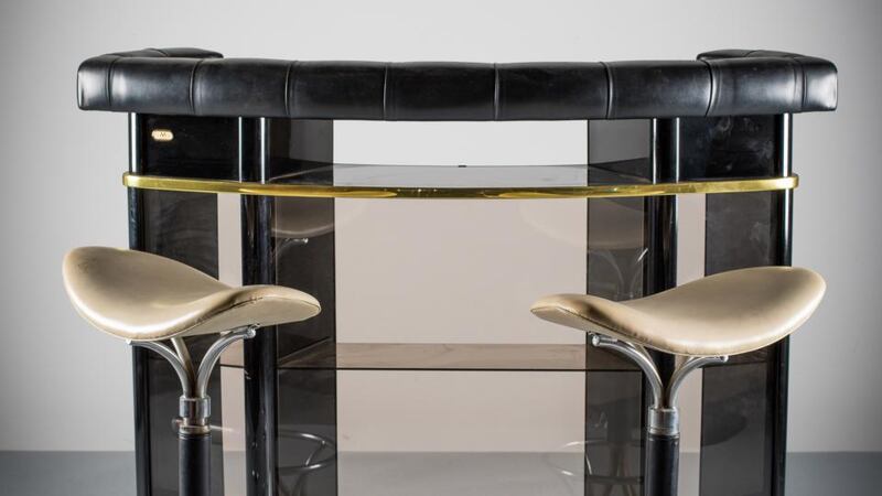 A lacquer and smoked-glass cocktail bar, French 1970s by “Martin”, and a pair of 1970s bar stools in cream upholstery on a chrome swivel base