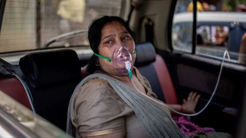 A Covid patient breathes with the help of oxygen provided by a gurdwara, a Sikh house of worship, in New Delhi, India. Photograph: Altaf Qadri/AP Photo