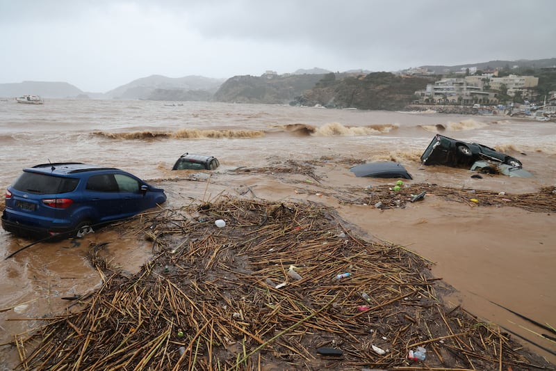 Cars carried away by floods at the popular resort of Agia Pelagia. Photograph: Costas Metaxakis/AFP via Getty Images