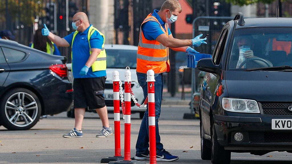Workers at a drive-through Covid-19 test centre in Leicester. Photograph: Darren Staples/Bloomberg