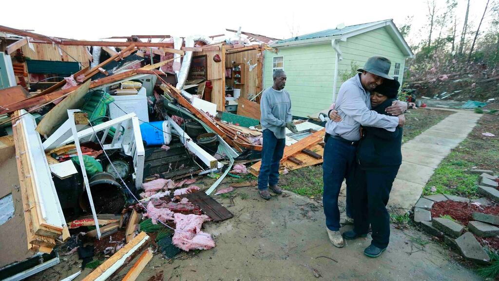 Phyllis Evans gets a hug from Harvey Payne after a tornado struck Holly Springs, Mississippi on Thursday. Photograph: Reuters