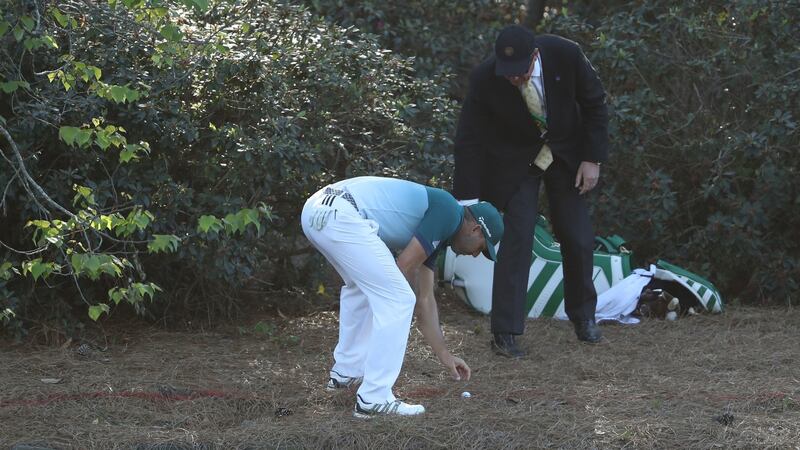 Garcia moves some pine needles beside his ball after a drop on the 13th. Photo: David Cannon/Getty Images