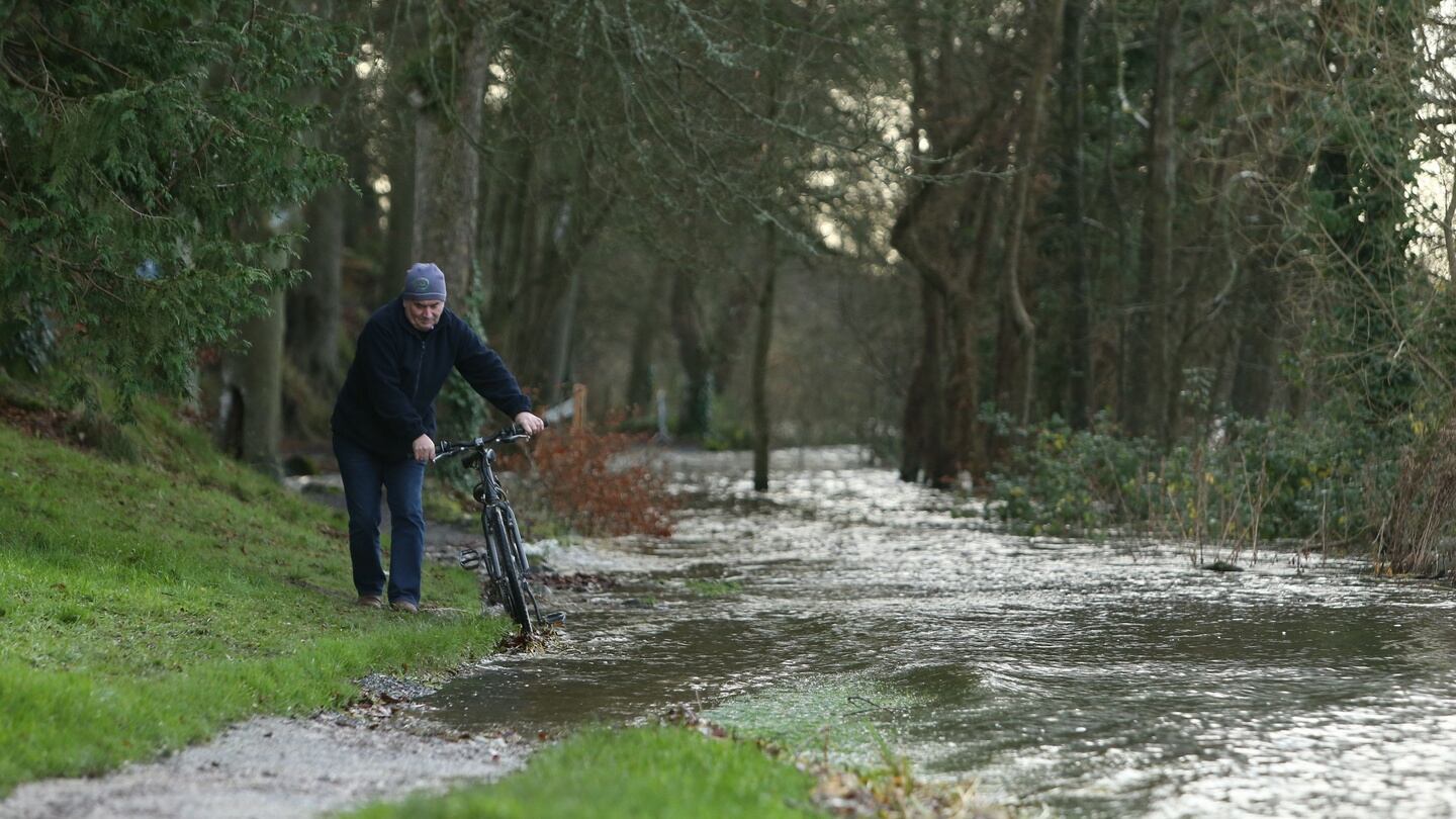 A cyclist tries to avoid water in a flooded park in Castleconnell,  Coy Limerick by the River Shannon as floods are set to worsen over the weekend. Photograph: PA