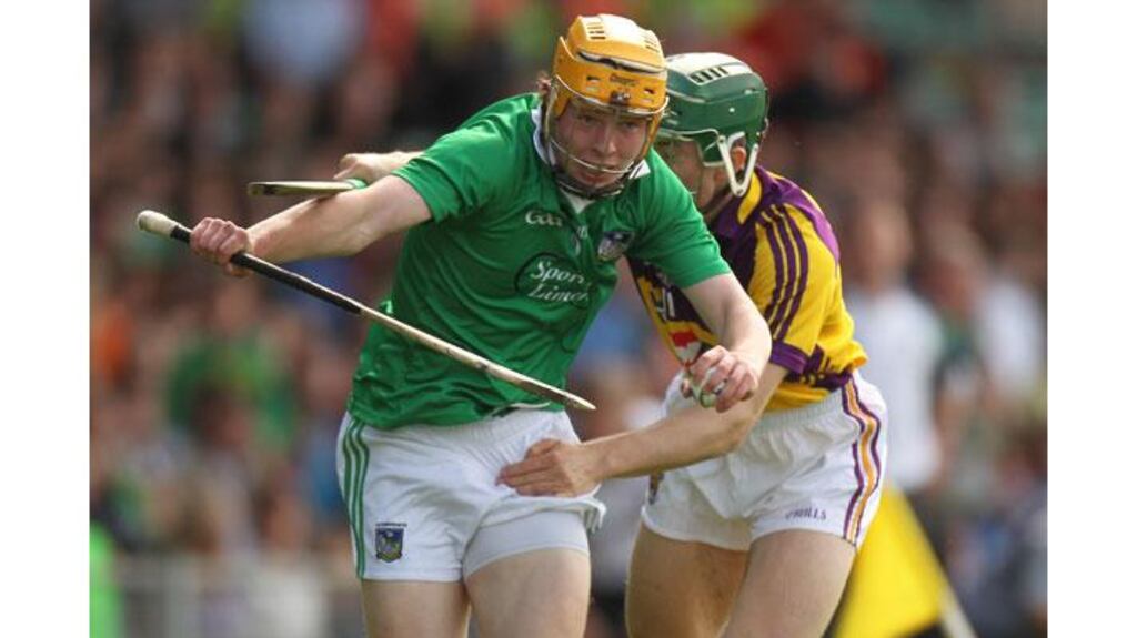 Limerick's Paul Browne is chased down by Harry Kehoe of Wexford during the All-Ireland SHC Qualifier Phase 2 at the Gaelic Grounds. Photograph: Billy Stickland/Inpho