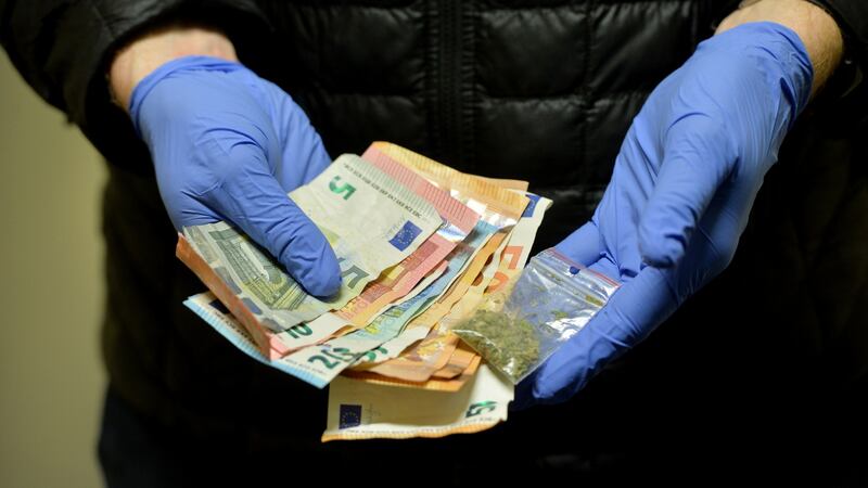 Gardaí display cash and drugs seized after a search of a Dublin rickshaw driver. Photograph: Alan Betson