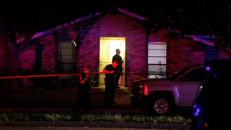 Police officers at work at the scene of a shooting at a home in Texas in which seven people died. Photograph: AP