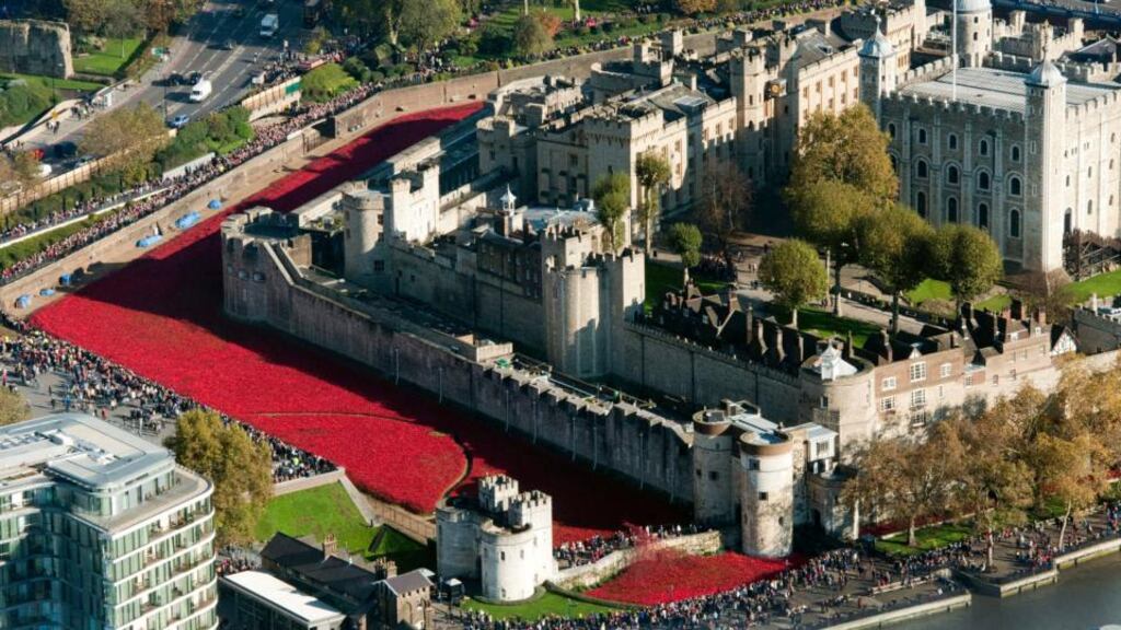 ‘The poppy display has been praised for the simple but powerful manner in which it has remembered the dead, but not everybody is satisfied.’ Above, an aerial view of visitors looking at the Tower of London’s “Blood swept Lands and Seas of Red” poppy installation. Photograph: Hannah McKl/EPA