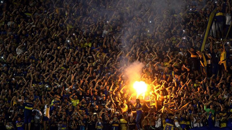 Boca Juniors’ fans light a flare before their match against Colombia’s Junior in the Copa Libertadores in Buenos Aires. Photograph: Reuters