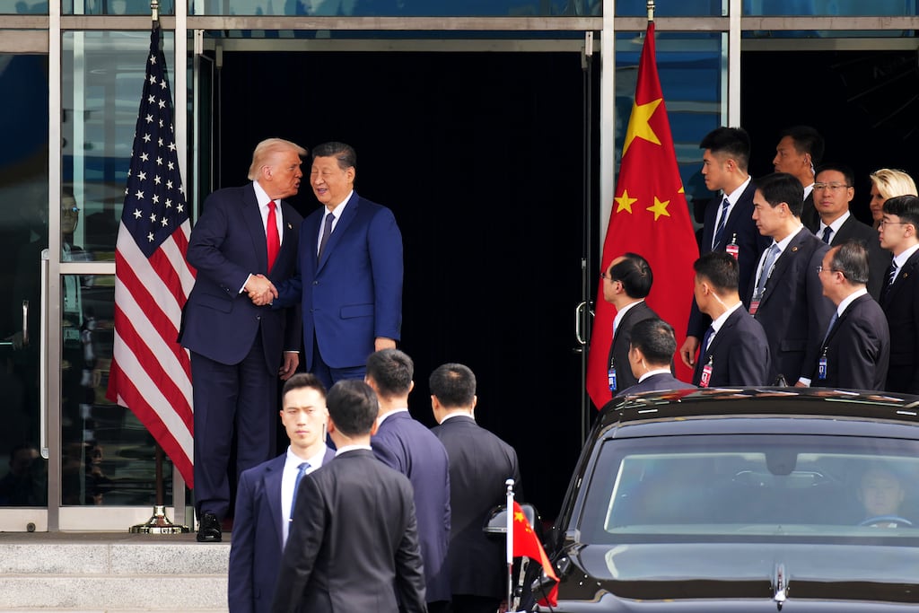 US president Donald Trump and Chinese president Xi Jinping shake hands following a bilateral meeting in Busan, South Korea. Photograph: Andrew Harnik/Getty Images