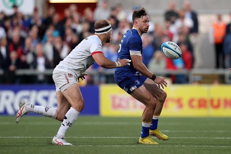 Leinster's Hugo Keenan offloads as he is challenged by Ulster's Will Addison. Photgraph: Bryan Keane/Inpho
