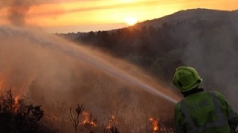 Firefighters attend to a gorse fire on Caggigoona commons, Kilmacanogue in Bray, Co Wicklow on Friday morning. Photograph: Declan Mallen