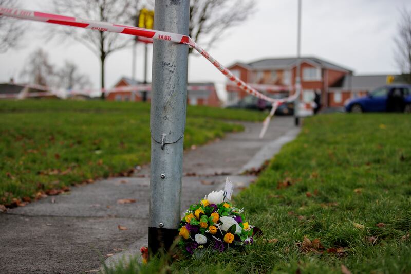 Flowers at the scene in the Edward Street area of Lurgan, Co Armagh, as two women and a man have been arrested after police launched a murder investigation. Detectives are investigating an incident which occurred in the early hours of Sunday. Picture date: Monday December 4, 2023. PA Photo. See PA story ULSTER Lurgan. Photo credit should read: Liam McBurney/PA Wire