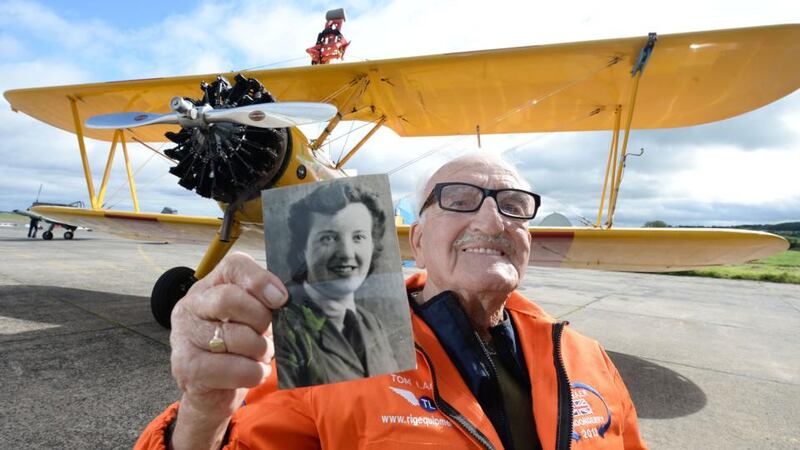 Tom Lackey holds up a picture of his late wife and wingwalking inspiration, Isobel. Photograph: Charles McQuillan/PA Wire