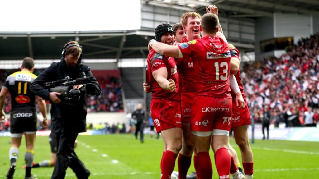 Scarlets’ Leigh Halfpenny and Scott Williams celebrate with try scorer Rhys Patchell during the  Champions Cup quarter-final against La Rochelle at  Parc y Scarlets. Photograph: James Crombie/Inpho
