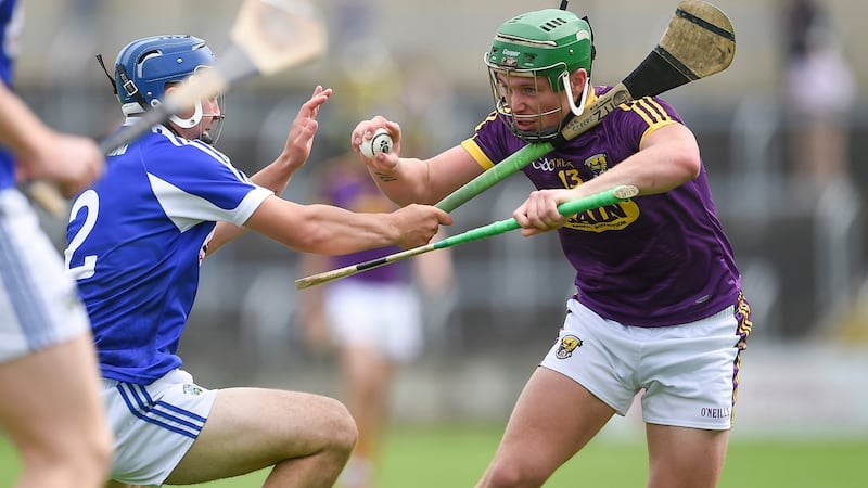 Wexford’s Ciaran Lyng with Lee Cleere of Laois during the Leinster senior hurling championship quarter-final at O’Moore Park, Portlaoise. Photograph: Tommy Grealy/Inpho