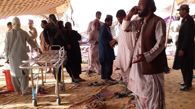 People gather at the bomb blast site in Pakistan’s restive Balochistan province. Photograph: Banaras Khan/AFP/GettyImages