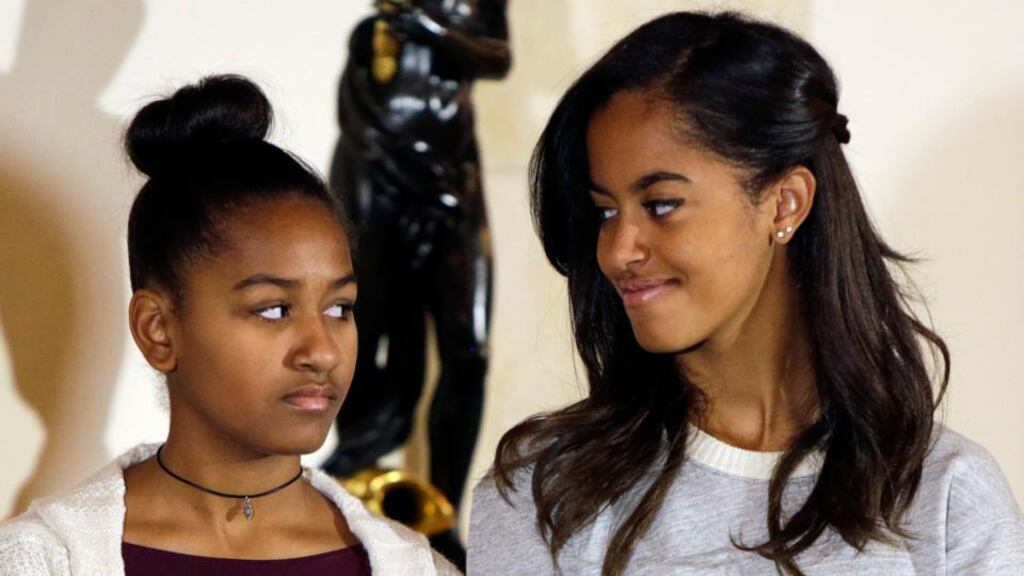 US president Barack Obama’s daughters Sasha (L) and Malia listen to their father during the pardoning of the National Thanksgiving turkey at the White House in Washington on November 26th. Photograph: Reuters