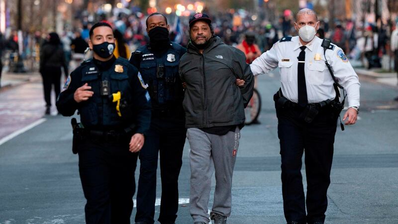 An anti-Trump demonstrator is arrested at Black Lives Matter plaza as pro-Trump supporters rally in Washington. Photograph: Andrew Caballero-Reynolds/AFPGetty Images