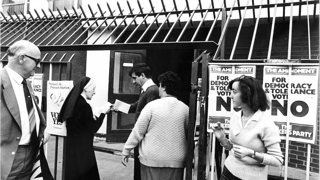 A nun hands out Yes leaflets at Basin Lane polling station in Dublin on the day of the abortion referendum in 1983. Photograph: Pat Langan