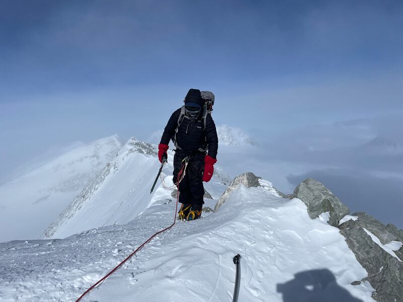 Rory McHugh climbing up the summit ridge. Six down, one to go.