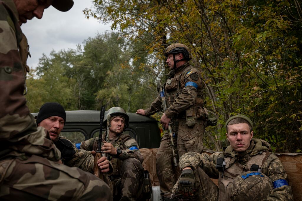 Ukrainian soldiers ride in the back of a truck near Lyman, Ukraine. Photograph: Nicole Tung/The New York Times