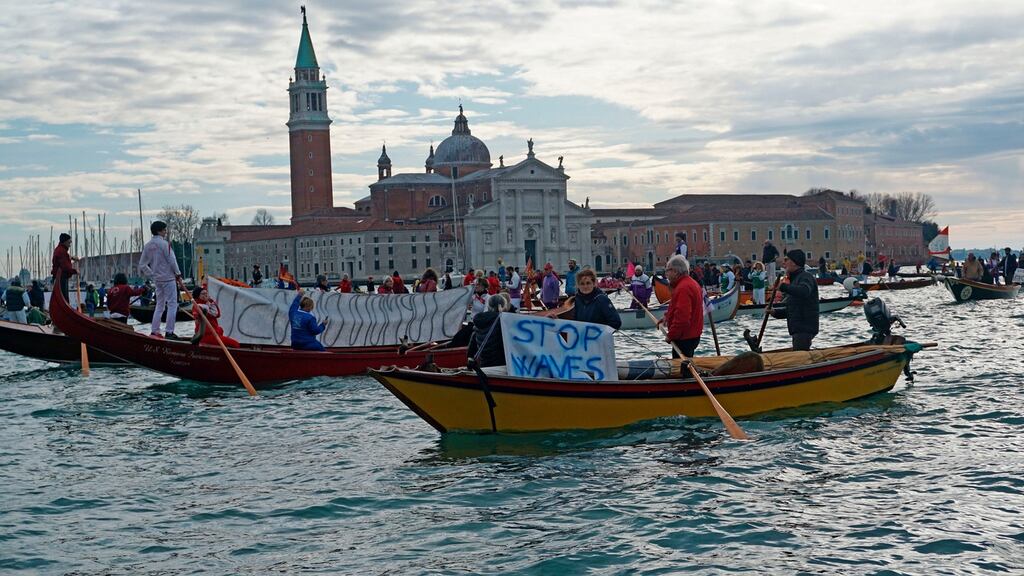 Rowing and sailing boats sail along the St Mark’s basin in Venice, Italy, as Venetians protest against the damage caused by waves created by large motorboats on Sunday. Photograph: Anteo Marinoni/LaPresse via AP