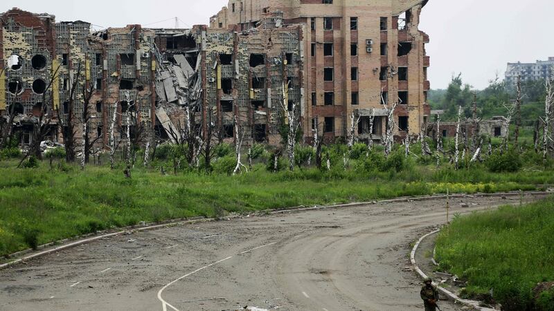 An armed pro-Russian separatist of the self-proclaimed Donetsk People’s Republic (DNR) walks in front of the destroyed Donetsk International Airport on June 1st, 2016. Photograph: Aleksey Filippov/AFP/Getty Images