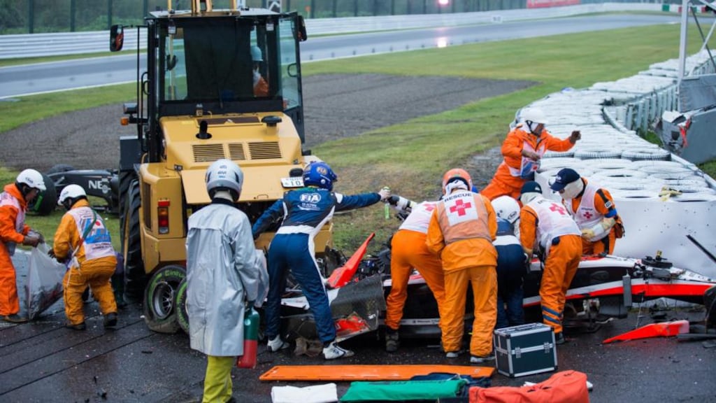 Medical staff treat French driver Jules Bianchi after his car slid off the track and crashed in wet conditions at the Japanese Grand Prix at Suzuka. The Marussia driver was later airlifted to hospital and is reported to be in a serious condition. Photograph: Hiroshi Yamamura/EPA
