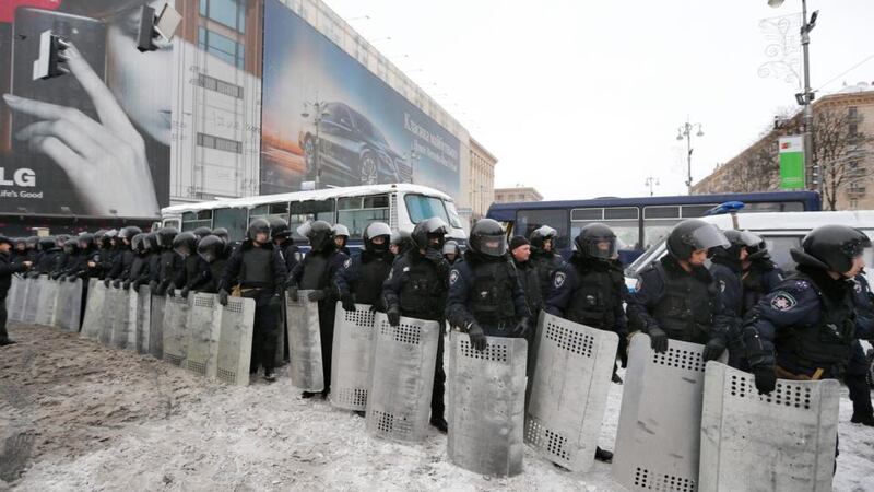 Soldiers of Ukrainian Interior forces form line near of barricade which was built by protesters to block the way to the Independence Square in Kiev. Photograph: Sergey Dolzhenko/EPA
