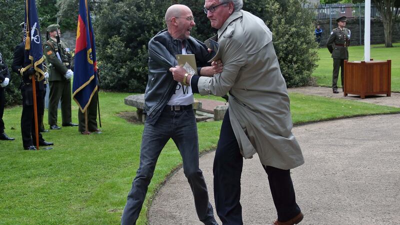 Kevin Vickers Ambassador of Canada to Ireland (wearing light coloured mac jacket) tackles Brian Murphy. Photograph: Collins