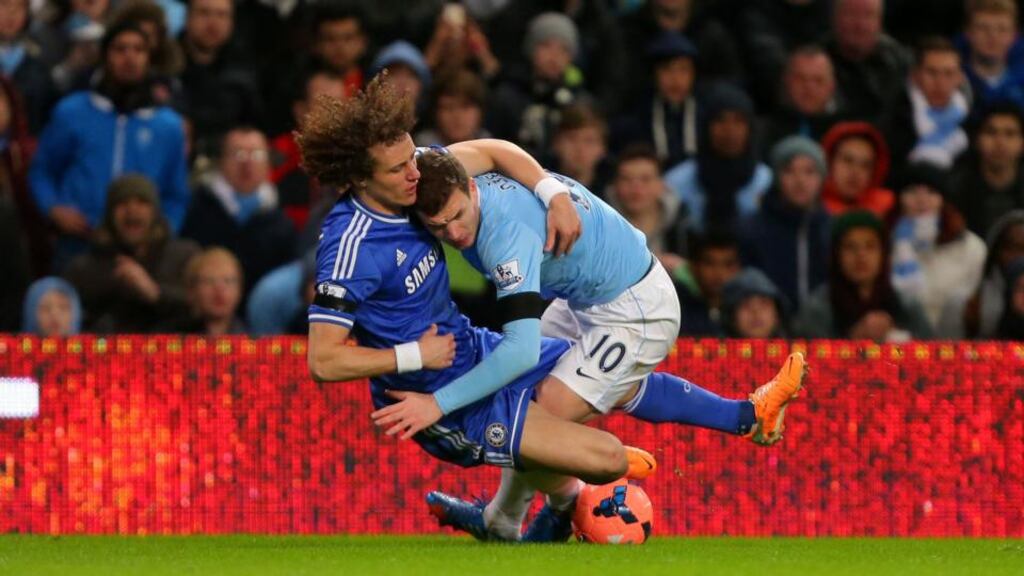 Manchester City’s Edin Dzeko battles for the ball with David Luiz at the Etihad Stadium. Photograph: Dave Thompson/PA Wire.