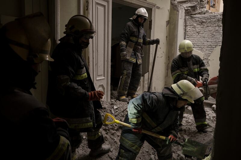Emergency workers search for bodies under the debris of the regional administration building in Kharkiv. Photograph: Felipe Dana/PA