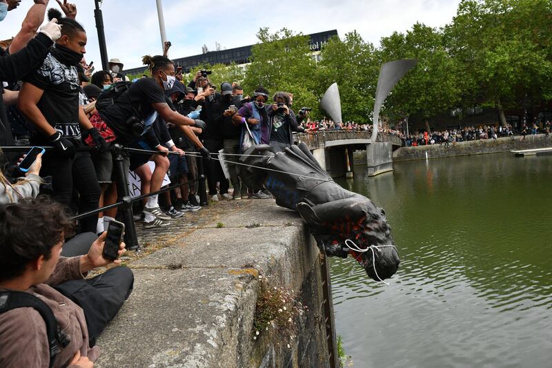 Protesters topple a statue of slave trader Edward Colston into Bristol harbour during a Black Lives Matter rally in June 2020. Photograph: Ben Birchall/PA