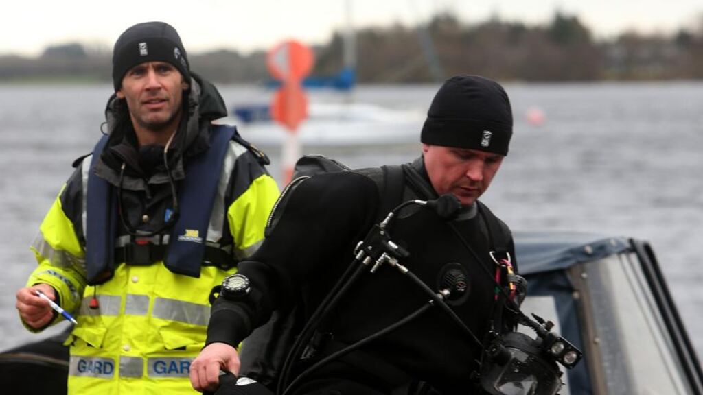 Members of the Garda sub aqua unit return to shore during the continuing search of Lough Ree in Co Westmeath for a man after the boat he was in with two others capsized. Photograph: PA