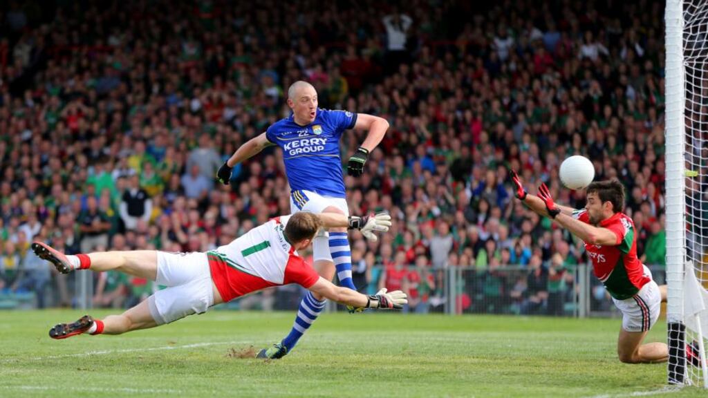 Kerry’s Kieran Donaghy scores a goal past Mayo goalkeeper Robert Hennelly and Ger Cafferkey. Photograph: ©INPHO/Cathal Noonan